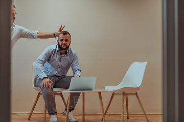 Image showing Programmers have fun on a break from work while working together to solve various programming codes