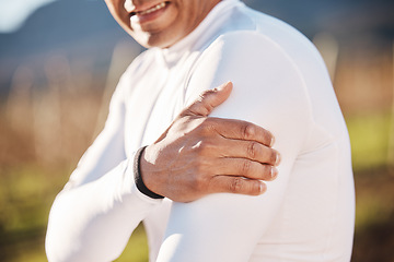 Image showing Hand, shoulder and injury with a runner man outdoor for cardio or endurance exercise in nature. Pain, arm and emergency with a male athlete suffering from cramp after an accident while running