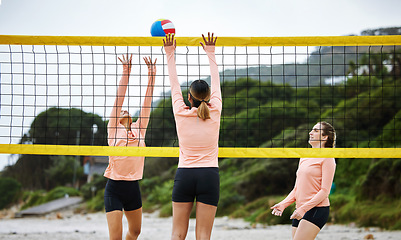 Image showing Volleyball, beach and summer with sports women playing a game outdoor for training or competition. Team, sport and ball with female friends on the sand by the coast to play a competitive match