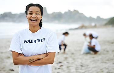 Image showing Portrait, smile and volunteer woman at beach for cleaning, recycling and sustainability. Earth day, laughing and proud female with arms crossed for community service, charity and climate change.