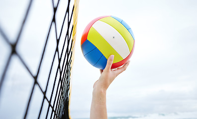 Image showing Hands, fitness and beach net volleyball with woman scoring goals in competition, game or match. Sports, training and female athlete holding ball in tournament to score for exercise or workout outdoor