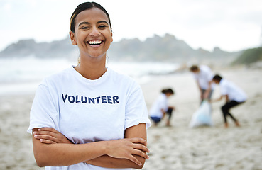 Image showing Smile, portrait and volunteer woman at beach for cleaning, recycling and sustainability. Earth day, laughing and proud female with arms crossed for community service, charity and climate change.