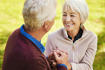 Image showing Old couple, holding hands with love and comfort outside in park with smile and happiness together with bonding. Happy, man and woman with travel, relationship with marriage and trust in retirement