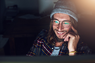 Image showing Internet, laptop and man streaming online video at night or evening with a smile reading an email, website or web. Person, young and male browsing using wifi on a computer and working late