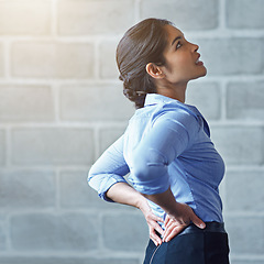 Image showing Back pain, office stress and business woman with muscle injury, health risk and fatigue on mockup wall. Uncomfortable female worker, spine problem and bad posture of injured body, scoliosis and joint
