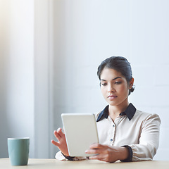 Image showing Business woman, tablet and reading in office with serious internet research or strategy for goals. Young executive, touchscreen and brainstorming for ideas, focus or website management in mockup