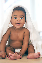 Image showing Adorable baby, black kid and blanket for play, fun and newborn on nursery room floor, happiness and relax. Happy young infant child, girl and body of healthy development, growth and nurture in house