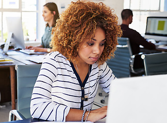 Image showing Black woman serious in startup and typing on laptop in modern office as copywriter or journalist, creative and content research. Wifi, busy female and productivity with copywriting at media company