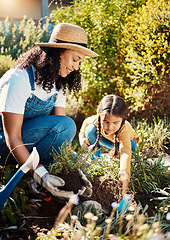 Image showing Black family, children or gardening with a mother and daughter planting plants in the backyard together. Nature, kids or landscaping with a woman and female child working in the garden during spring