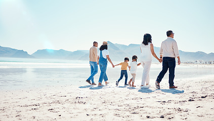 Image showing Beach, love and big family holding hands while walking on a vacation, adventure or weekend trip. Travel, seaside and children on walk with their parents and grandparents by the ocean while on holiday