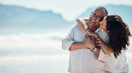 Image showing Love, romance and mature couple on beach, embrace and kiss with happy relationship and mockup. Romantic retirement vacation, senior woman and man hugging on tropical ocean holiday travel with smile.