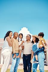 Image showing Happy, bonding and big family on the lawn at a house for happiness, visit and hug. Smile, affection and children, parents and grandparents on a garden of a home for playing, conversation and love