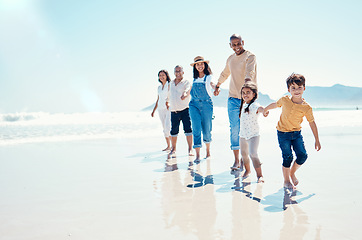 Image showing Happy, portrait and a big family holding hands at the beach for a walk, bonding and playing. Love, carefree and children walking at the sea with grandparents and parents on a holiday in Spain