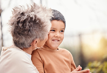 Image showing Children, family and love with a grandmother kissing her grandson outdoor in the garden of their home. Kids, kiss or cute and a senior woman bonding with her male grandchild together in summer