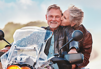 Image showing Travel, kiss and senior couple on motorcycle for adventure, freedom and road trip on weekend in retirement. Love, travelling and happy man and woman ride on motorbike for holiday, vacation or journey