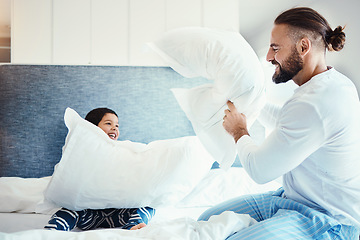 Image showing Happy, love and father in pillow fight with his child on the bed in the bedroom of family house. Happiness, smile and dad being playful with his boy kid while bonding, playing and having fun at home.