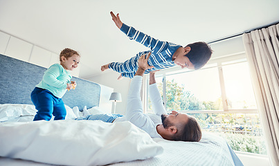 Image showing Love, father and boy on bed, airplane and quality time with happiness, break and vacation. Dad, children and kids in bedroom, son in air and smile for playing, games and relax on weekend and bonding