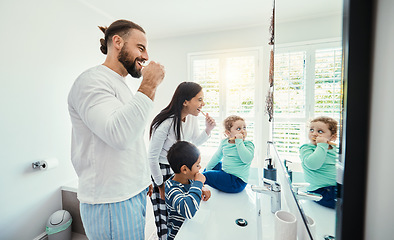 Image showing Happy family, man and kids in bathroom for brushing teeth, healthcare and bonding to start morning in house. Young father, mother and children with toothbrush, smile and mirror for medical self care