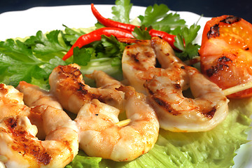 Image showing Grilled prawns on bamboo sticks served on lettice