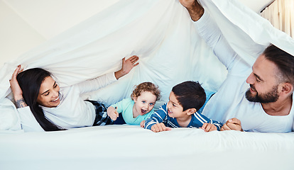 Image showing Love, parents and children with blanket, quality time and bonding together on weekend, break and smile. Family, mother and father with kids, bedroom and happiness with joy, smile or carefree to relax