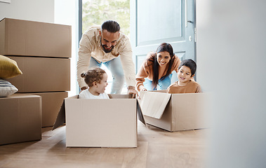 Image showing Family play in cardboard box for new house, moving and real estate celebration, investment and excited children. Homeowner parents or mom, dad and kids in boxes game bonding in property home together