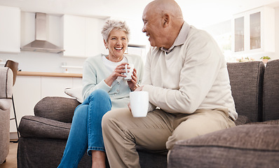 Image showing Love, coffee and elderly couple relax on a sofa, happy and laughing, talking and bonding in their home. Tea, chill and senior man and woman enjoying retirement, relationship and humor in living room