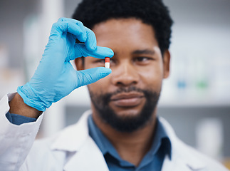 Image showing Worker, pharmacist or holding medicine in research, medical healthcare or wellness innovation in retail store clinic or hospital study. Pharmacy, black man or employee and pills drugs or product help