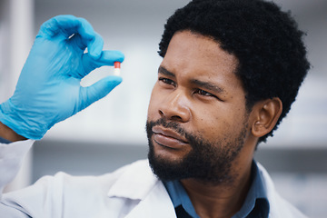 Image showing Black man, pharmacist or holding pills in research, medical healthcare or wellness innovation in laboratory clinic or hospital study. Pharmacy, worker or employee with medicine drugs or product help