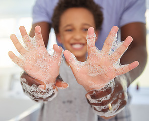 Image showing Black family, washing hands and soap foam with a father and child in a bathroom with a smile. Blurred background, papa helping and hygiene support of a kid with dad together with happiness and care