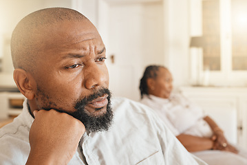 Image showing Face, frustrated or argument and a black man looking angry or upset while thinking about a fight with his wife in their home. Divorce, idea and fighting with a senior couple sitting in a living room