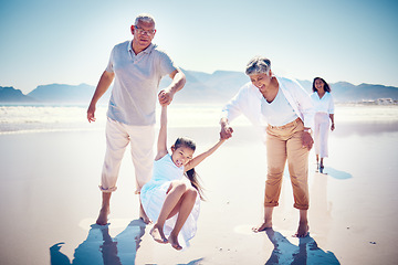 Image showing Beach, family holding hands and grandparents with kid playing and walking on ocean sand together. Fun, vacation and happy senior man and woman with children bonding, quality time and summer in nature