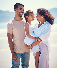 Image showing Happy family, beach and hug of a mother, father and girl together by the ocean. Nature, sea and love of a mom, dad and child from the Philippines on a vacation with parents on travel holiday