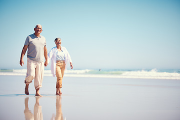 Image showing Holding hands, summer and an old couple walking on the beach with a blue sky mockup background. Love, romance or mock up with a senior man and woman taking a walk on the sand by the ocean or sea