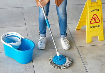 Image showing Floor mopping, cleaning sign and mop bucket with water and woman doing safety and hygiene work. Wellness, female worker and maid with disinfection container and tile ground with cleaner and janitor