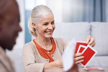 Image showing Playing cards, game and a senior woman in a retirement home having fun while sitting in a living room. Card games, happy and gambling with senior friends in a house to play poker or relax together