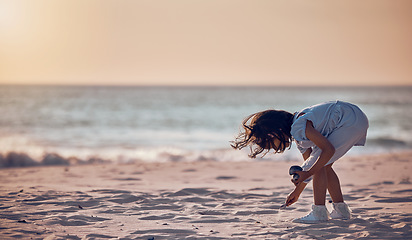 Image showing Mockup, girl and beach for summer vacation, sand and search for seashells, happiness and water. Female child, kid and young person on seaside holiday, collection or freedom with peace, relax or break
