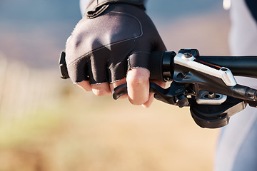 Image showing Man hands, gloves and holding on bicycle for training, triathlon sports and cardio transportation. Closeup cyclist, bike gear and handlebar with lever, brakes and outdoor fitness for cycling athlete