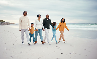 Image showing Grandparents, parents and children walking on beach enjoying holiday, travel vacation and weekend together. Big family, nature and happy people holding hands for bonding, quality time and love by sea