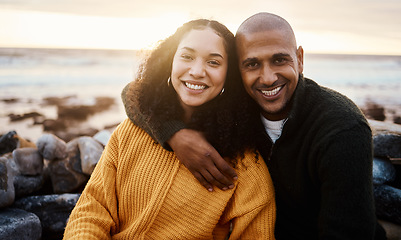 Image showing Romantic, happy and portrait of a couple at the beach for a date, bonding or sunset in Bali. Love, hug and young man and woman smiling while relaxing at the ocean for vacation or an anniversary