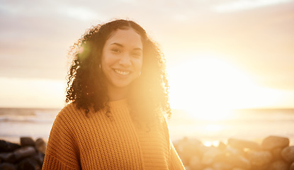 Image showing Travel, sunset and portrait of a woman at the beach while on a zen vacation or weekend trip. Happy, smile and calm female from Puerto Rico by the ocean while on a seaside holiday or adventure.