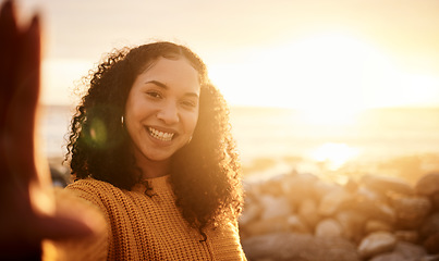 Image showing Selfie, sunset and mockup with a black woman on the beach during summer for a holiday or vacation. Portrait, sunrise and flare with an attractive young female posing for a photograph on the coast