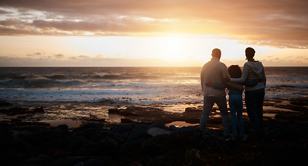Image showing Family, sunset and mockup with people on the beach looking at the view while bonding in nature. Rear view silhouette of a man, woman and child standing together enjoying the sunrise over the horizon