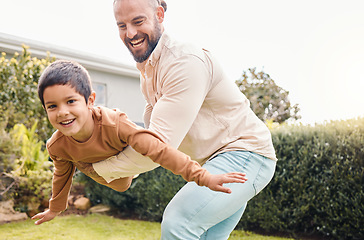 Image showing Carefree, flying and portrait of a father with a child in a garden for freedom, play and bonding. Happy, laughing and dad holding a boy kid to fly while playing in the backyard of a house together