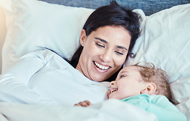 Image showing Love, baby and mother relax in bed, waking up and bonding, happy and smile together in their home. Rest, family and mom with child in a bedroom, laughing and sharing special moment of motherhood