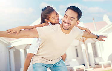 Image showing Flying, happy and father with a child for playing, bonding and quality time in a home garden. Carefree, smile and dad with a girl for support, outdoor activity and playful together in a backyard