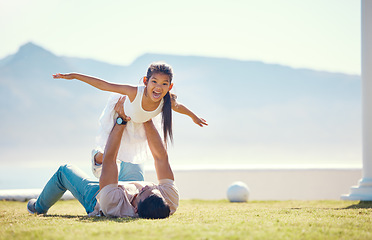 Image showing Love, father and girl in air, outdoor and happiness on summer vacation, break and relax together. Family, dad holding daughter to sky and parent with child, smile or quality time on grass and holiday