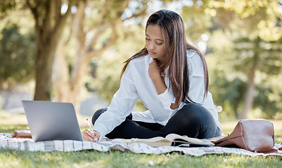 Image showing Nature, laptop and student studying in the park for a university test, exam or assignment. Technology, outdoor and woman writing notes while working on a college project with a computer in a garden.