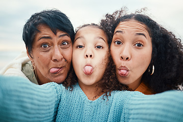 Image showing Funny, tongue out and portrait of a family selfie, silly and goofy at the beach in Bali. Comic, crazy and girl taking a photo with a mother and grandmother for a playful memory on holiday at the sea