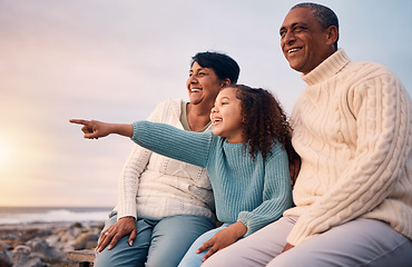 Image showing Beach, black family and a girl pointing outdoor with grandparents while looking at the view together during sunset. Nature, summer or kids with a senior man and woman bonding with their grandchild