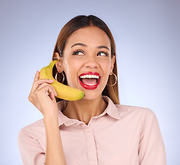 Image showing Woman, studio and banana phone call for hello, happiness or comic communication for makeup, beauty or fashion. Gen z girl, funny chat or conversation with mobile fruit for diet, wellness or cosmetics